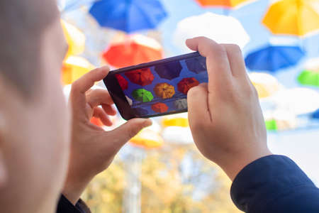 Colorful umbrellas. Bottom view. Conceptual art object. No labels or identification marks. Place for your text. Colorful background. Concept of a good mood and protection from problems. Sky is visibleの写真素材