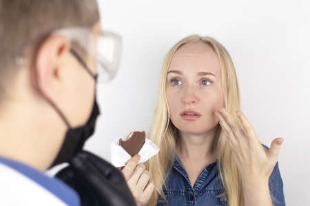 Patient complains to the doctor about the loss of taste. Girl at the reception of the therapist...