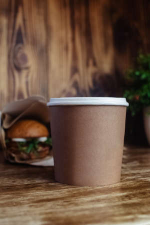 Food delivery. The girl holds paper bags with fast food in her hands. The concept of countering covid 19. Delivery from a restaurant or cafe. Unpacking meal containersの写真素材