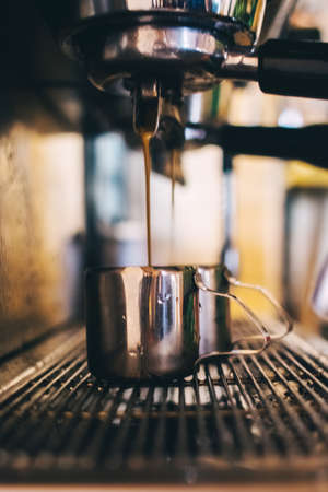 Close-up of a barista preparing coffee. The process of making cappuccino in a coffee machine....