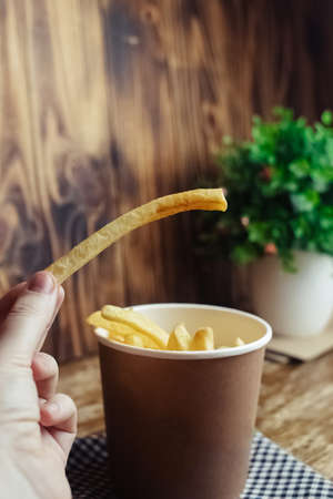 Top view of French fries. Fry dip. The concept of fast food, quick bites and restaurants for catering. Potatoes in carton and ketchup. Vertical photo.の写真素材