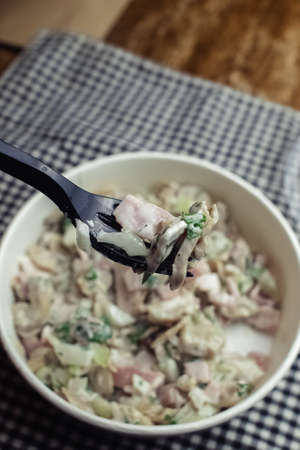 Salad in a disposable glass close-up. Healthy and fast food. Takeaway cafe. Disposable tableware for food safety. Healthy fast foodの写真素材