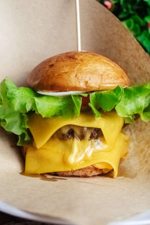 Close-up of a double burger. Adult fast food in a restaurant or cafe. Macro photo of burger...