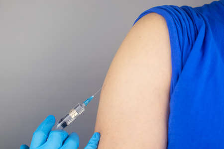 Concept. Chipping through vaccinations. Government conspiracy. Vaccination and implantation of a tracking microchip into the human body. Implantation of electronic technologies into the human bodyの写真素材
