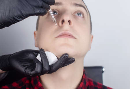 Beard growth. The master in the barber shop applies a special oil to enhance the growth of the beard and mustache. Stimulation of hair follicles on the face. Only for men. Specialist in the barbershopの写真素材