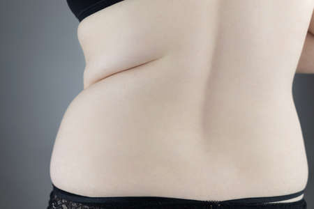 Close-up girl from behind. Side Pleats. Excess weight. Adoption non-ideal figure. Body positivity...