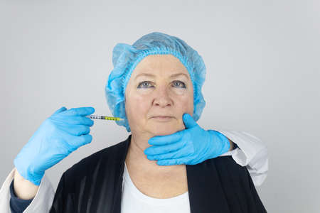 Botulinum toxin injection. Senior woman at the appointment with a beautician who is preparing to...