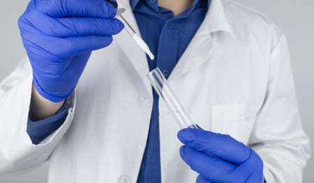 Medical laboratory assistant checks a test tube with sperm. spermogram. male fertility test. Semen...