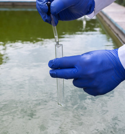 water sample. treatment facilities. Quality control of water that has been purified and processed. The laboratory assistant collects material for research. Liquid in a test tube. Sewage treatmentの写真素材