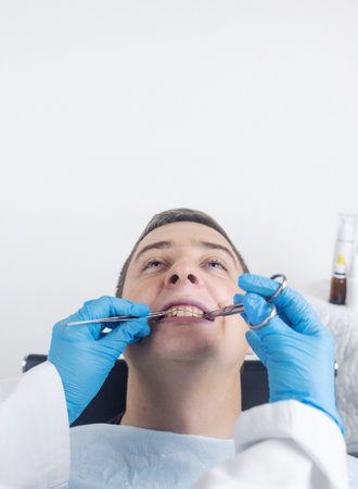 Installation of braces, bridges and a dental plate to correct teeth. An orthodontist installs a...
