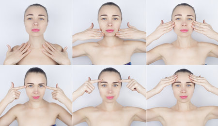 Girl shows massage lines on her face. Model runs her hands over her face, performing a rejuvenating massage procedure. Instructions on how to carry out the procedure are drawn with arrows. Cosmetologyの写真素材