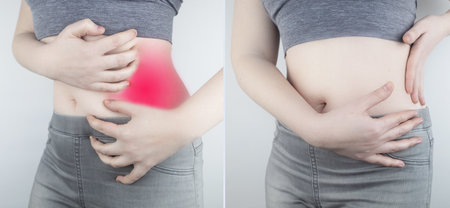 Pain in left side. Girl holds on to the left side of the abdominal cavity. Inflammation of the intestines, spleen, sprains, overexertion, neuralgia, pain during menstruation. On the right photo no painの写真素材
