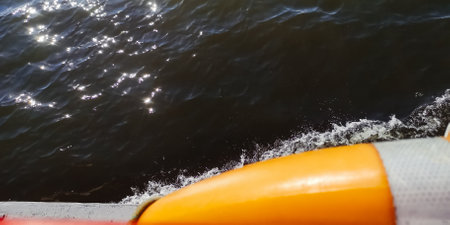 Lifebuoy. View of the water from a pleasure boat. The shine of the sun on the waves creates an...