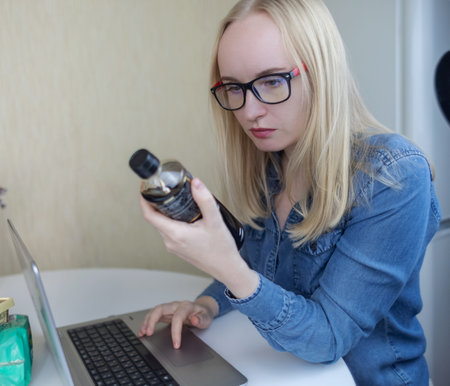 Woman reads instructions for food products at home. Checking labels on goods. Study of product compositions. Search Internet for descriptions of product gradients. Useful or harmful. Nutritionologyの写真素材