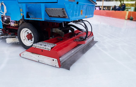 Ice cleaning machine. General and close-up of a professional machine for preparing an ice rink. Place for text. Speed skating, hockey and other winter sportsの写真素材