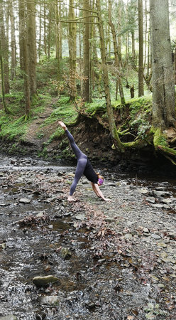 Yoga in nature. Girl in the middle of forest conducts a retreat for herself. Individual practice in unity with nature. Solopractic in meditation and Vedic exercises. Forests of the Carpathians, Ukraineの写真素材