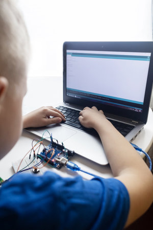 Programming for children. The boy is studying online at a robotics school for programming courses. Child learning control board codingの写真素材