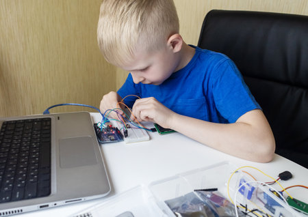 Programming for children. The boy is studying online at a robotics school for programming courses. Child learning control board codingの写真素材