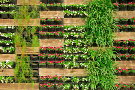 Bright flower floral decorative wall fence, vertical flowerbed plant pot. Stock image.	の写真素材