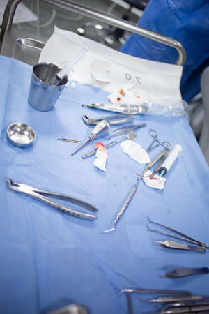 Medical tray table with dental tools and equipment during teeth surgery
