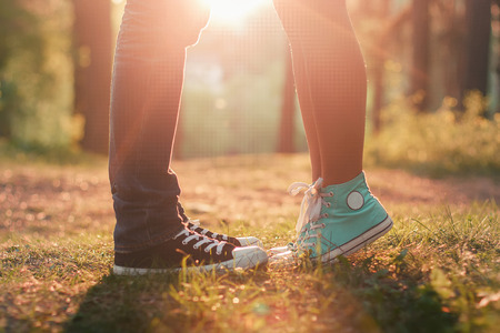 Young couple kissing in summer sun light. Kiss love standing