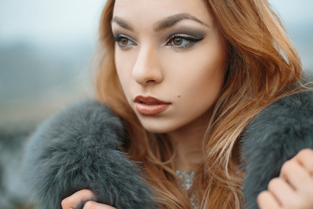 Beautiful girl in a fur jacketの写真素材