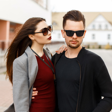 Young beautiful couple in stylish fashion clothes with sunglasses on the street.の写真素材