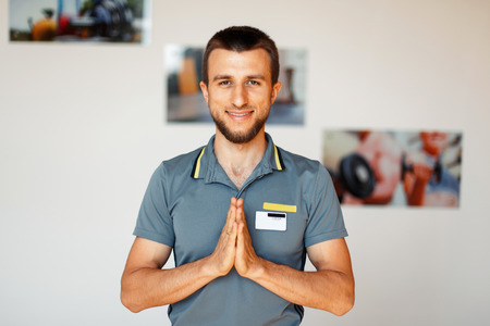 Young male fitness instructor in the hall. Yoga coachの写真素材
