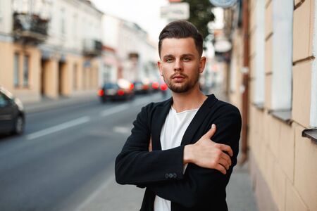 Handsome stylish man in business clothes on the street on a summer dayの写真素材