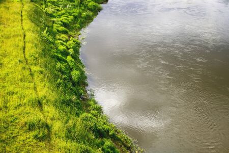 Fisherman is fishing in the river. Green grass and lake. Top viewの写真素材