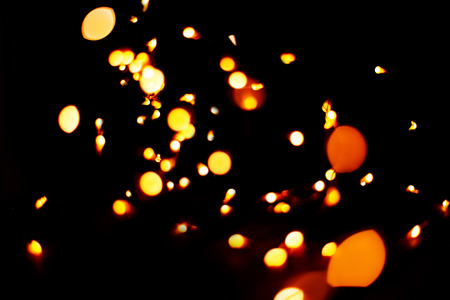 Festive Christmas and New Year lights. glitter vintage lights background. dark gold and black. defocusedの写真素材