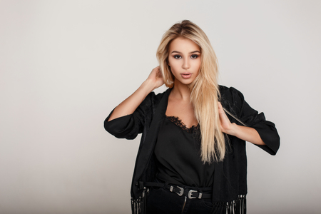 Young blond model woman in a fashion black dressの写真素材