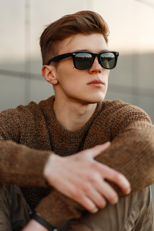Fashionable portrait of a handsome young man with stylish sunglassesの写真素材