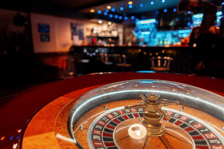 Casino roulette with wooden golden table in the barの写真素材
