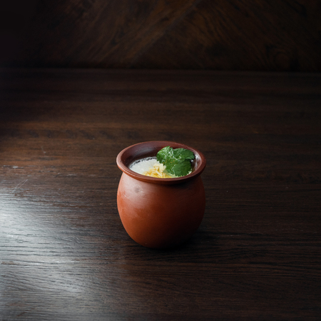 Sour-milk drink "Matsoni" in a ceramic pot in a restaurant. Traditional element of the Armenian and Georgian national cuisines.の写真素材