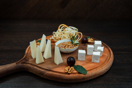 Assorted Caucasian cheeses. Dish is served with honey and nuts. Beautiful serving in the restaurant.の写真素材