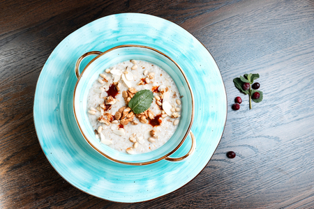 Delicious healthy breakfast of cereal with walnuts and pumpkin seeds on the table in the restaurant, which serves oriental cuisine. National Georgian dish.の写真素材