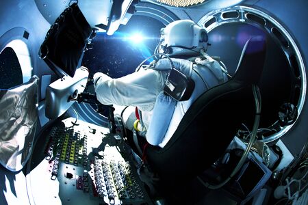 Spaceman sitting in a spaceship in space with a planet. Astronaut travels in space