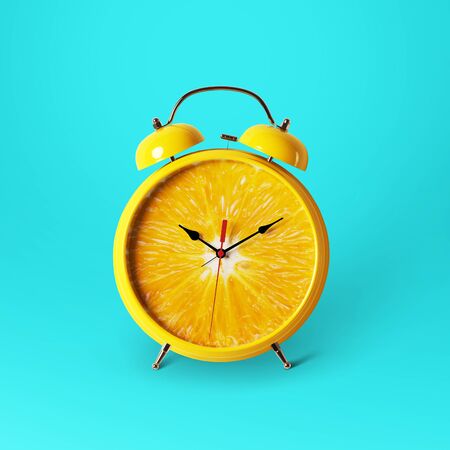 Creative idea layout fresh orange slice alarm clock on blue background. minimal idea business concept. Healthy lifestyle conceptの写真素材