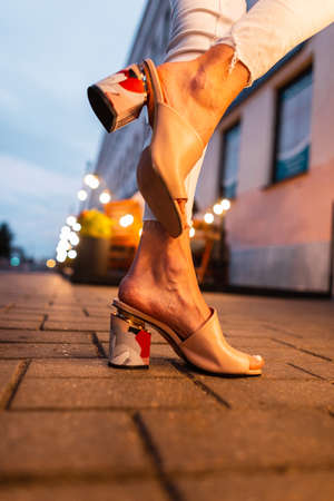 Female fashion summer shoes at night streetの写真素材
