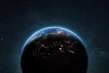 Blue planet earth with skyline and bright city lights in deep space with stars.の写真素材