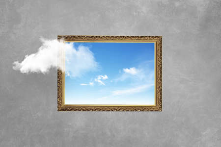 Vintage frame with blue sky on concrete wall. Think outside the box surreal minimal, concept. Creative ideaの写真素材