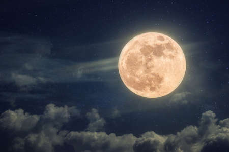 Amazing full moon on blue night sky with stars and clouds. Halloween wallpaperの写真素材