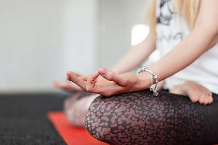 Instructor young woman sits in lotus position and meditates. Trainer does yoga. view from above....