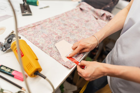 Tailor seamstress woman works in studio. Manufacture of wearing apparelの写真素材