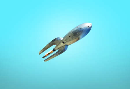 Vintage rocket on a blue background. Old spaceship takes off. travel to mars conceptの写真素材