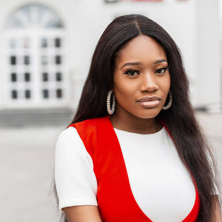 Fashionable portrait young black woman with beautiful eyes with sexy lips with long hair in white...