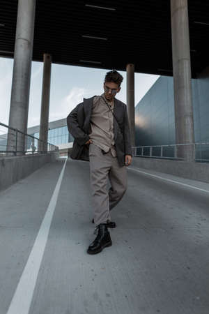 handsome hipster guy in fashion clothes suit walks in the city. urban male styleの写真素材