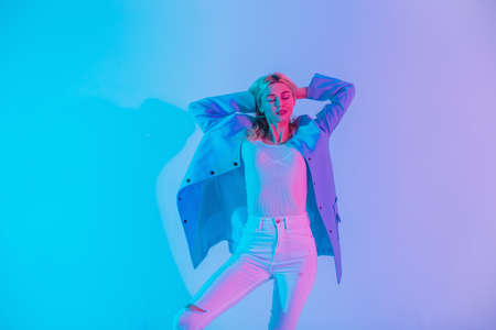 Multicolored creative portrait of a young pretty sexy woman model in fashionable elegant business...