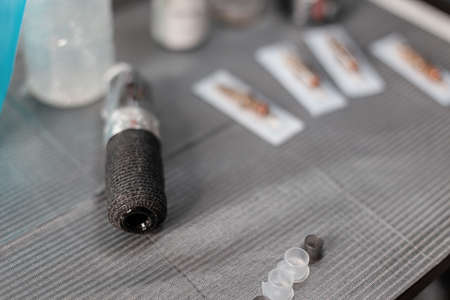 Master's tattoo table with typewriter and toolの写真素材